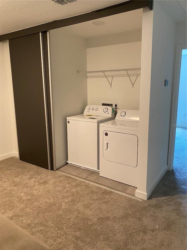 3432 Tranquil Trl, Kissimmee, FL 34747 - laundry room with carpet, washing machine and clothes dryer, and baseboards