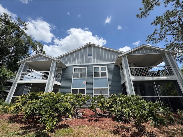 exterior space featuring board and batten siding and a balcony