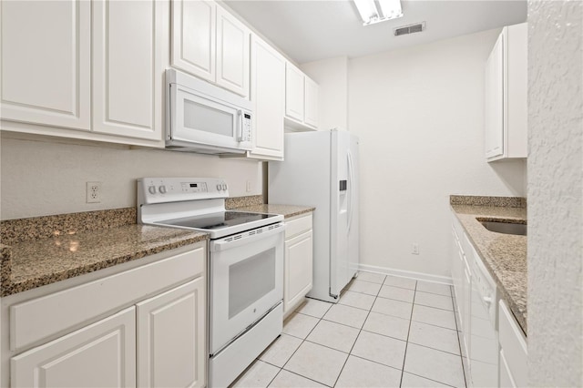 2484 San Tecla St Unit 106, Orlando, FL 32835 - kitchen featuring white cabinets, white appliances, and visible vents