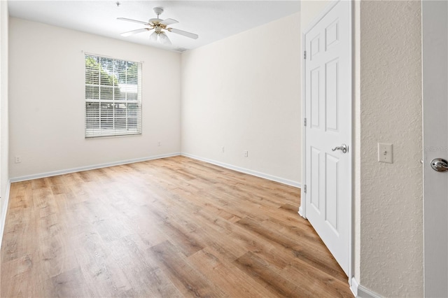 2484 San Tecla St Unit 106, Orlando, FL 32835 - unfurnished bedroom with a textured wall, light wood-style flooring, a ceiling fan, and baseboards
