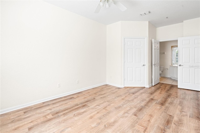2484 San Tecla St Unit 106, Orlando, FL 32835 - unfurnished bedroom featuring light wood-type flooring, ensuite bath, a ceiling fan, visible vents, and baseboards