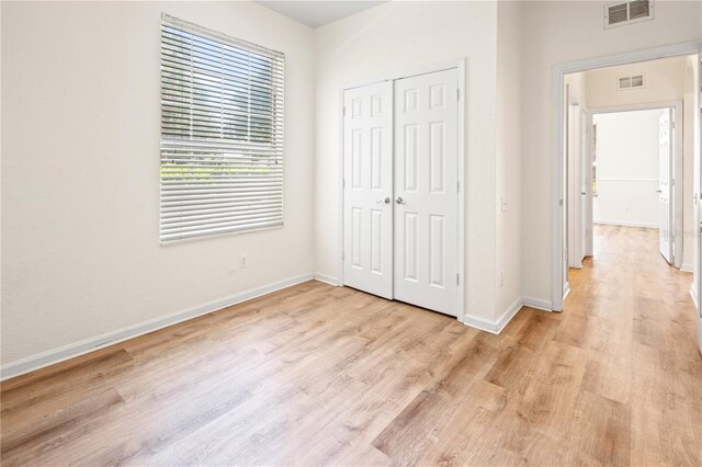 2484 San Tecla St Unit 106, Orlando, FL 32835 - unfurnished bedroom with a closet, visible vents, baseboards, and light wood-style flooring