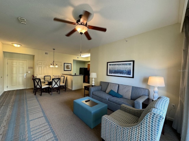 8125 Resort Village Dr Unit 51006, Orlando, FL 32821 - living room with baseboards, ceiling fan with notable chandelier, dark carpet, and visible vents