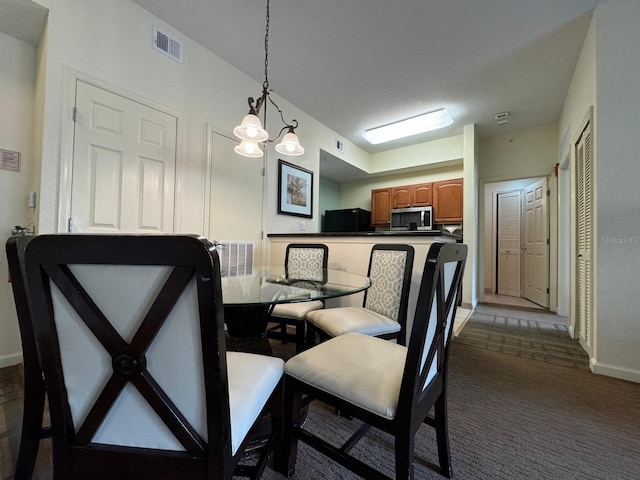 8125 Resort Village Dr Unit 51006, Orlando, FL 32821 - dining room featuring a chandelier, baseboards, visible vents, and dark carpet