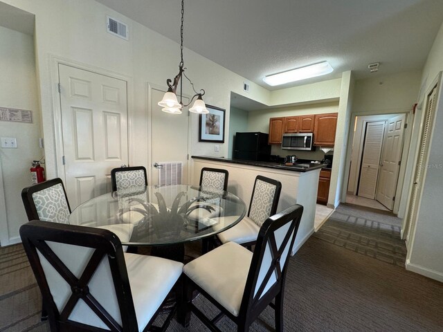 8125 Resort Village Dr Unit 51006, Orlando, FL 32821 - carpeted dining area with a chandelier, baseboards, and visible vents