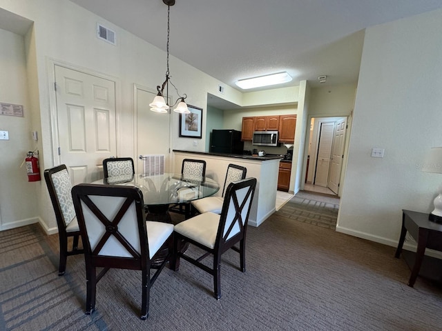 8125 Resort Village Dr Unit 51006, Orlando, FL 32821 - dining space featuring an inviting chandelier, baseboards, dark carpet, and visible vents