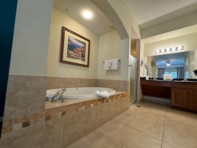 8125 Resort Village Dr Unit 51006, Orlando, FL 32821 - bathroom featuring a garden tub, tile patterned flooring, a tile shower, vanity, and a textured wall