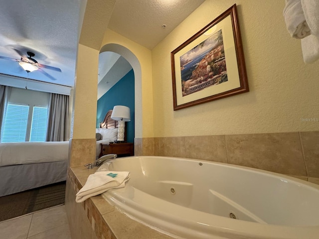 8125 Resort Village Dr Unit 51006, Orlando, FL 32821 - bathroom with tile patterned flooring, a whirlpool tub, a textured wall, and connected bathroom