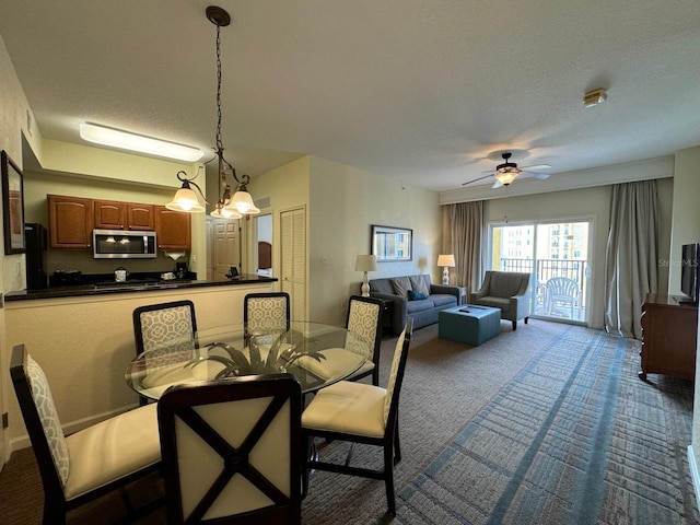 8125 Resort Village Dr Unit 51006, Orlando, FL 32821 - dining room featuring dark carpet, a ceiling fan, and a textured ceiling