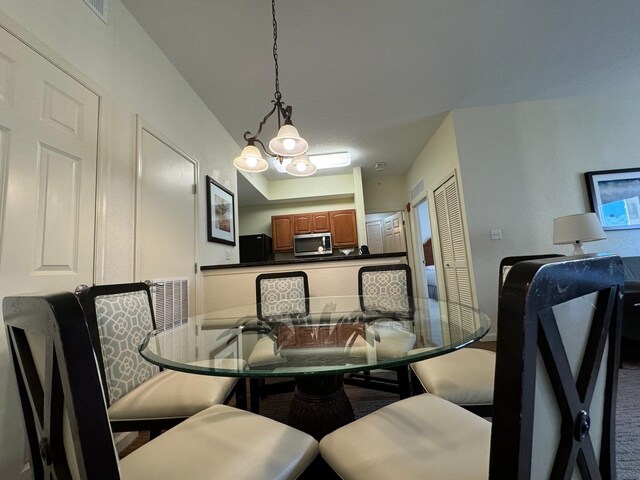 8125 Resort Village Dr Unit 51006, Orlando, FL 32821 - dining area featuring a notable chandelier