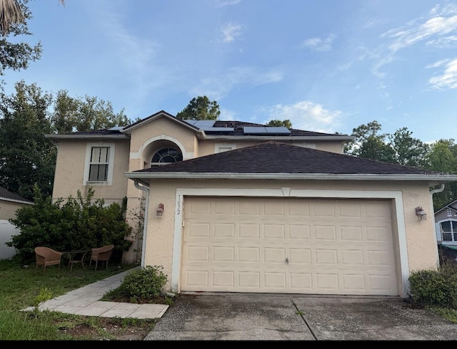 1632 Cornerview Ln, Orlando, FL 32820 - view of front of house featuring stucco siding, roof mounted solar panels, a garage, and driveway