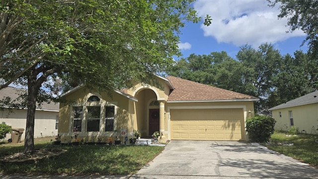ranch-style house with driveway, a shingled roof, a garage, and stucco siding