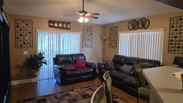 living room with ceiling fan, wood finished floors, and baseboards
