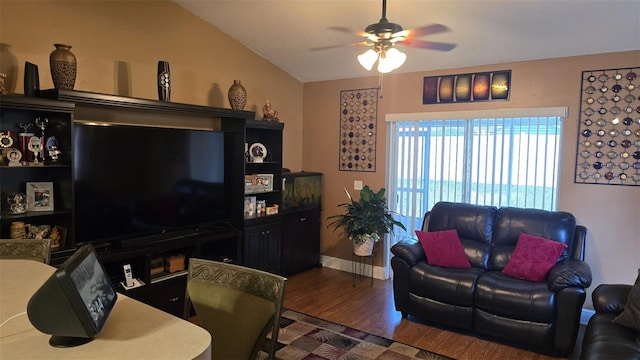 living area with lofted ceiling, baseboards, a ceiling fan, and wood finished floors