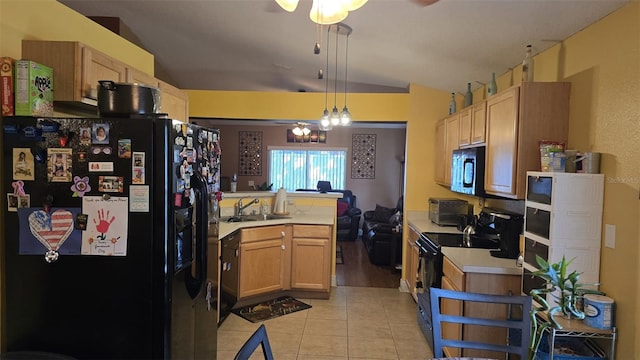 kitchen featuring a peninsula, black appliances, light tile patterned floors, and ceiling fan