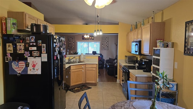 kitchen featuring a sink, light tile patterned floors, light countertops, and black appliances