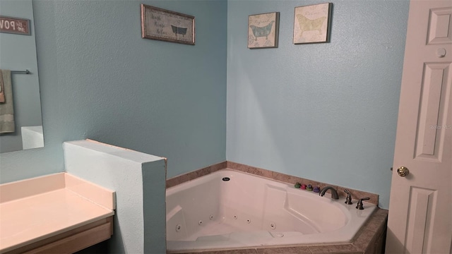 full bathroom with a textured wall and a whirlpool tub