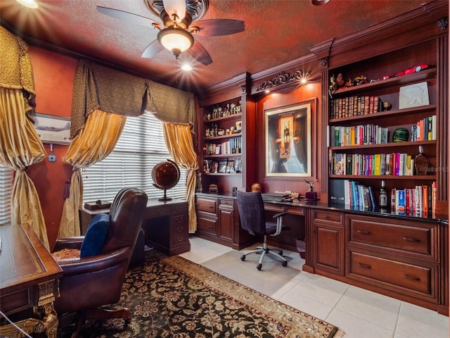 office space with built in desk, a textured ceiling, light tile patterned flooring, and ceiling fan