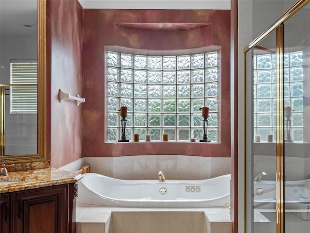 bathroom with a shower stall, vanity, radiator, and a tub with jets