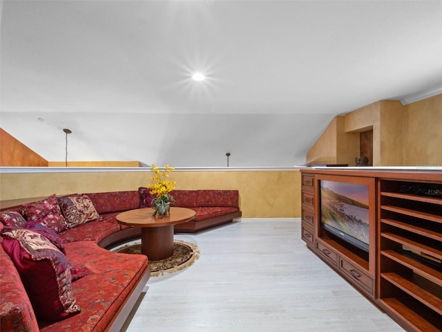living room with vaulted ceiling and wood finished floors