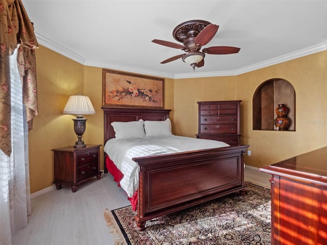 bedroom featuring ceiling fan, baseboards, ornamental molding, and wood finished floors