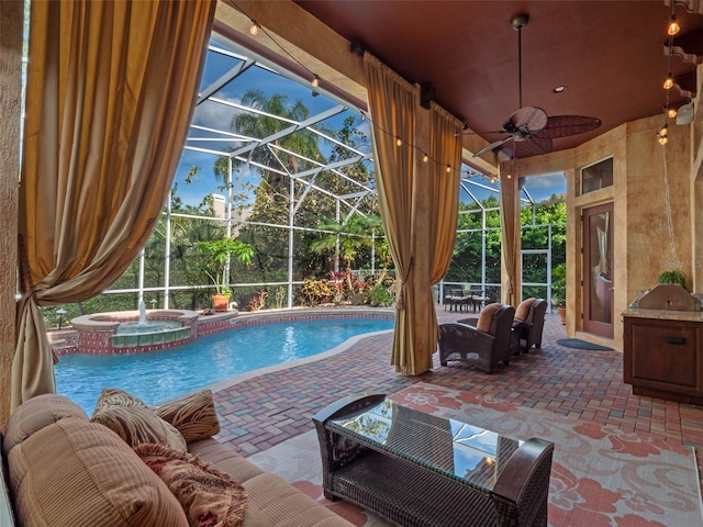 view of swimming pool with a patio, a pool with connected hot tub, a lanai, and a ceiling fan