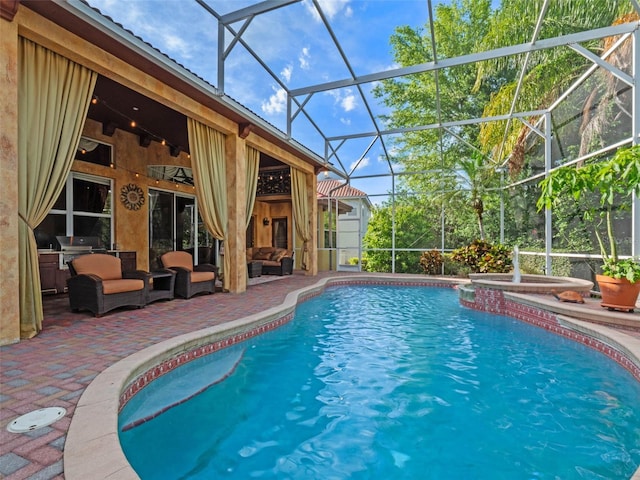 outdoor pool with outdoor lounge area, a ceiling fan, glass enclosure, a patio, and an in ground hot tub