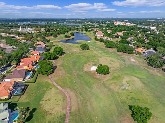 birds eye view of property with a water view and view of golf course