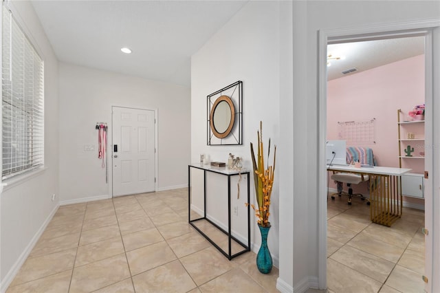 corridor featuring light tile patterned floors, visible vents, and recessed lighting