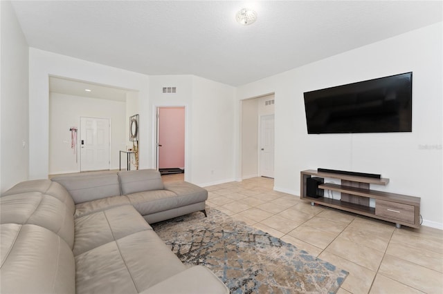 tiled living room with baseboards and visible vents