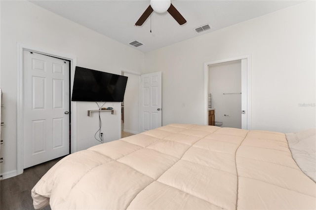 bedroom featuring a ceiling fan, connected bathroom, visible vents, and dark wood-style floors