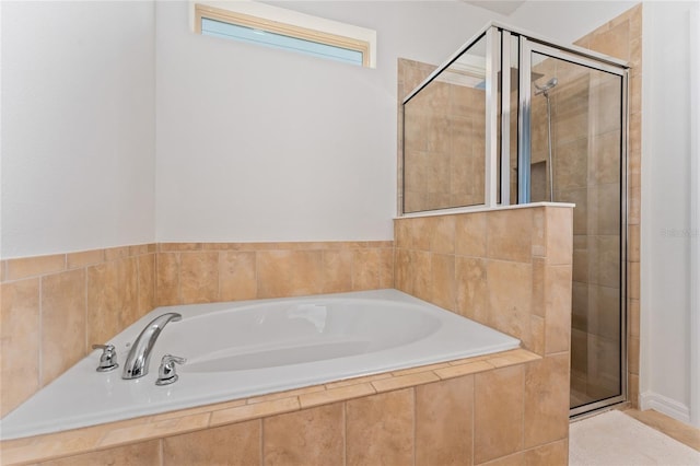 full bathroom featuring a garden tub and a stall shower