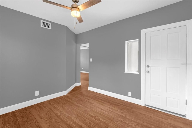 unfurnished room featuring visible vents, ceiling fan, wood finished floors, and baseboards