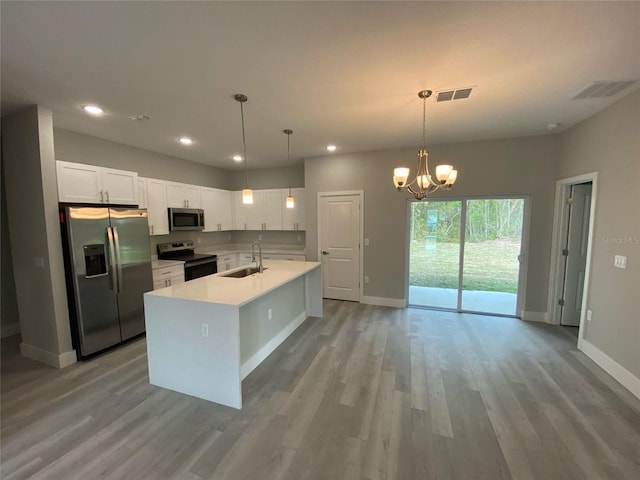 16435 SW 27th Ave, Ocala, FL 34473 - kitchen featuring stainless steel appliances, a sink, white cabinetry, light countertops, and recessed lighting