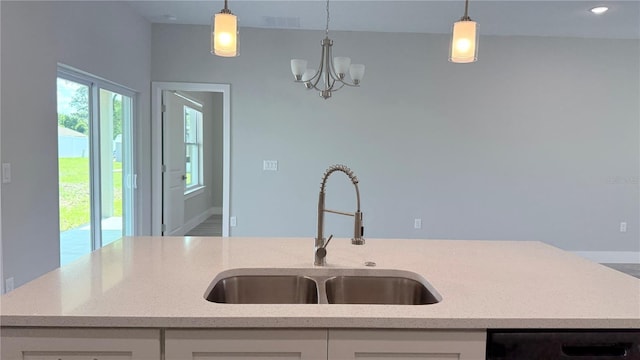 16435 SW 27th Ave, Ocala, FL 34473 - kitchen featuring a sink, dishwashing machine, white cabinetry, light stone countertops, and decorative light fixtures