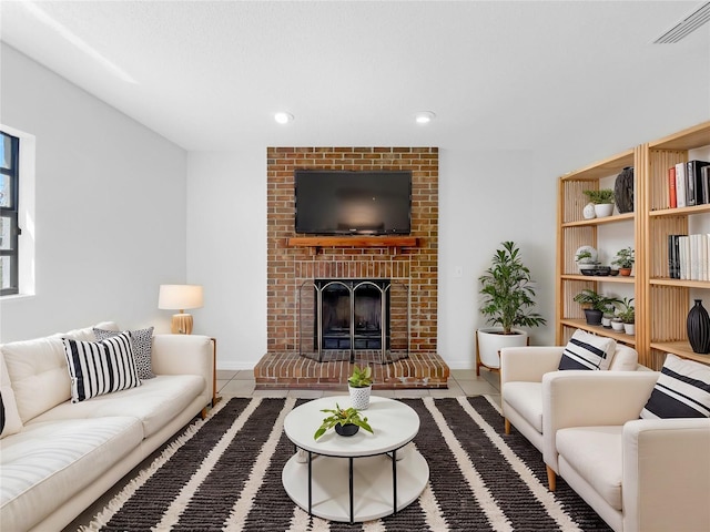 tiled living area featuring visible vents, baseboards, recessed lighting, and a brick fireplace