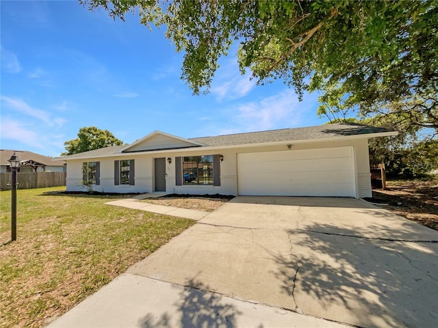 single story home featuring a garage, driveway, fence, and a front lawn