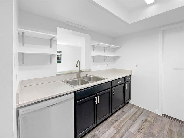kitchen with light wood-style flooring, light countertops, open shelves, dishwasher, and a sink