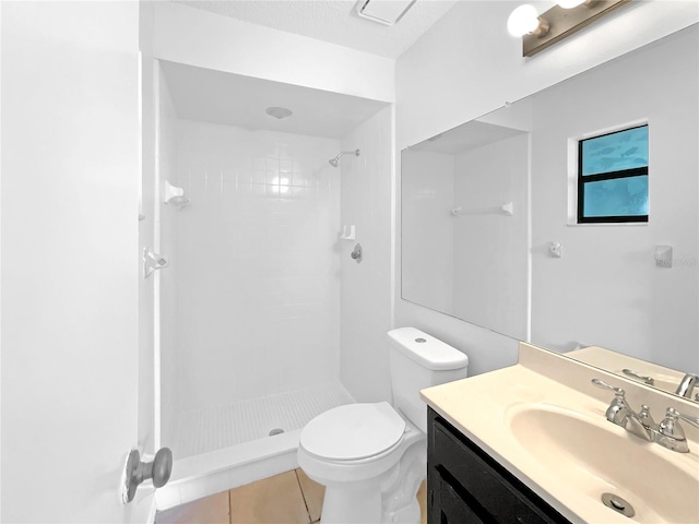 full bath with tile patterned floors, toilet, tiled shower, and vanity