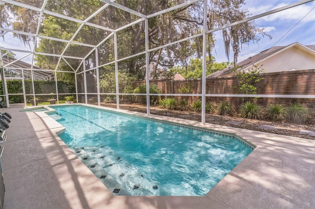 view of pool with a pool with connected hot tub, a patio, and a fenced backyard