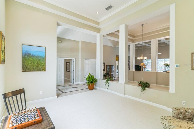 interior space featuring an inviting chandelier, carpet, ornamental molding, baseboards, and visible vents