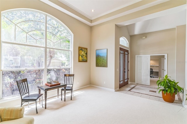 living area featuring crown molding, baseboards, light carpet, and plenty of natural light