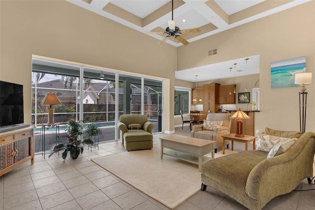 living area featuring coffered ceiling, visible vents, a ceiling fan, a high ceiling, and light tile patterned flooring