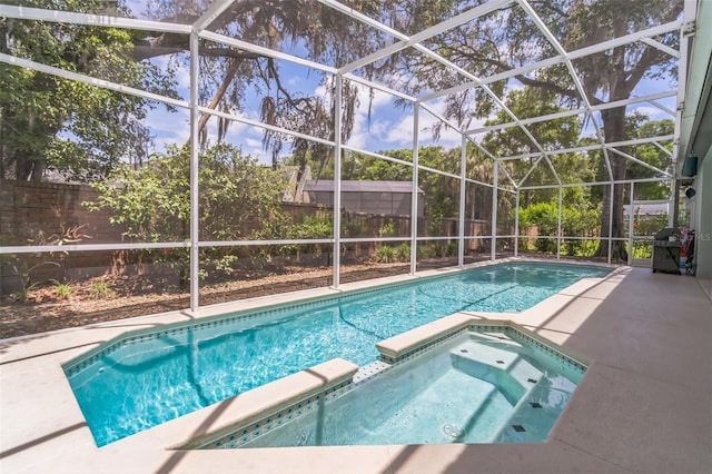 view of swimming pool with a patio area, glass enclosure, grilling area, a pool with connected hot tub, and a fenced backyard