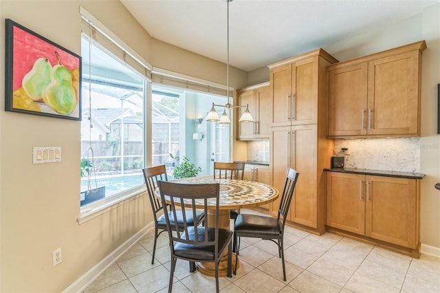 dining room featuring light tile patterned flooring and baseboards