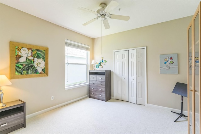 carpeted bedroom featuring baseboards, a ceiling fan, and a closet