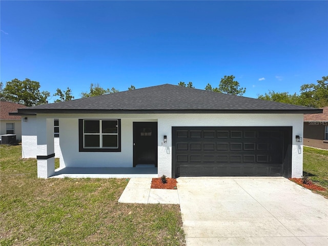 view of front facade featuring an attached garage, central AC, a front lawn, stucco siding, and concrete driveway