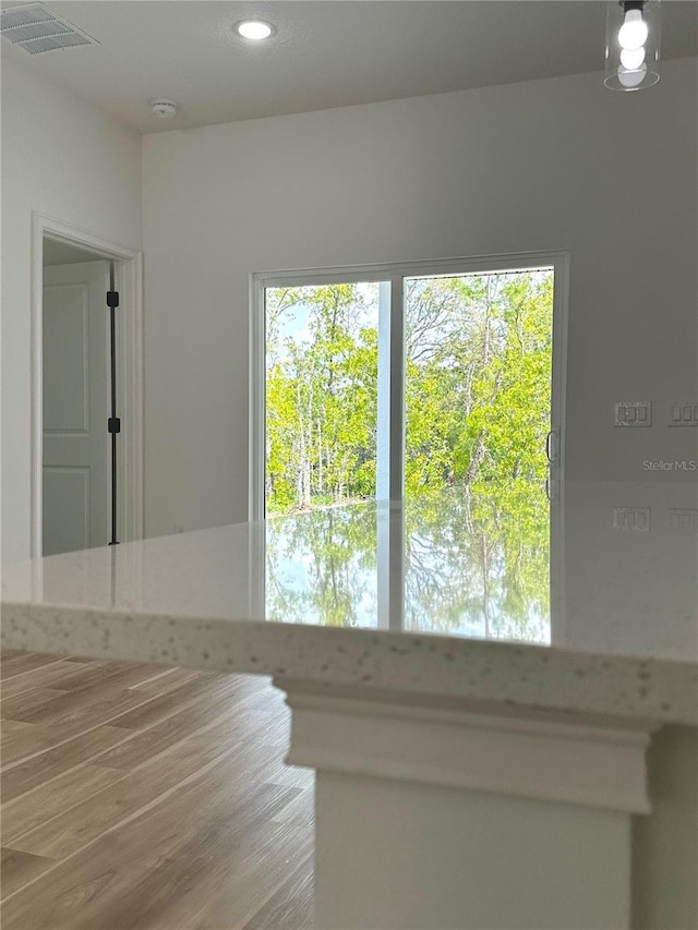 interior space featuring recessed lighting, visible vents, and wood finished floors