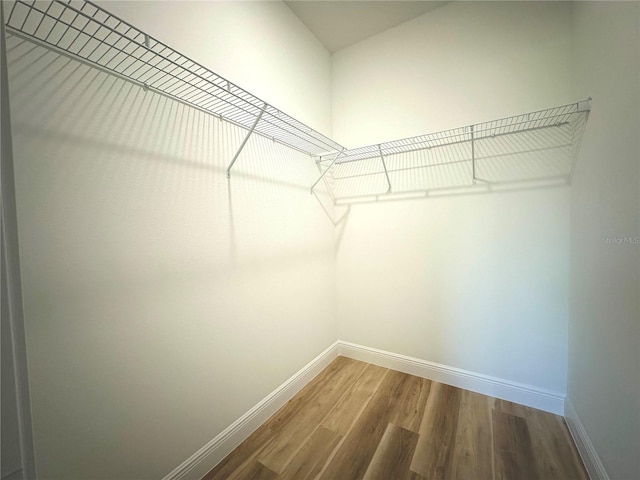 spacious closet with wood finished floors