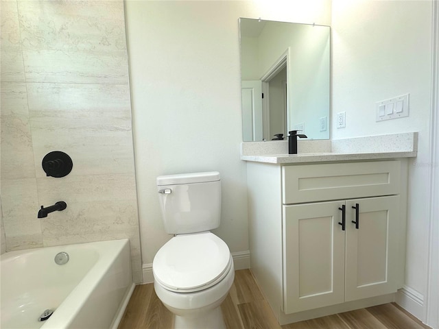 bathroom with vanity, toilet, and wood finished floors